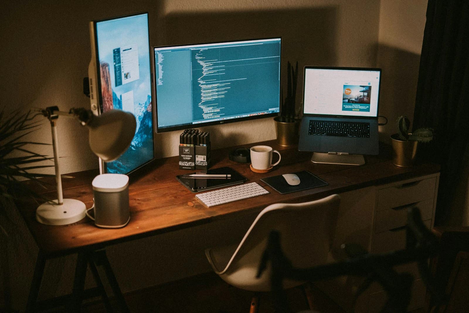 Flat screen monitors and a MacBook Pro on a desk